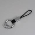 Porte-clés créatif en cuir tressé noir avec anneaux métalliques argentés et attache - Noir + Argent