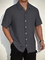 Detail shot of men's casual short sleeve shirt featuring grey seersucker textured fabric - S / Tops / Dark Gray