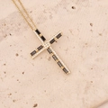 Detail of 18K gold cross necklace with black and white zircon on beige stone surface - Black and White Gemstone Inlaid Cross (3#)