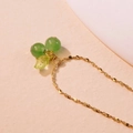 Close-up of golden cherry necklace with green bead pendants and leaf detail - Single Necklace / Green