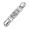 Detail of vintage silver shawl clip featuring floral relief and metal duckbill clamps - Silver Hollow Floral