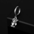 Detailed view of a vintage silver owl pendant on a round stainless steel earring hoop - Owl