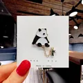 Cute panda enamel pin with a small green bamboo charm on a stylish display card - 102*Panda with Bamboo Chain Pin