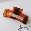 Detail view of large amber rectangle hair claw clip with shell pattern texture - Rectangular Hollow Style (S150-41) / 10.5cm / Amber