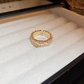 Top view of gold open ring with square and round zircons in a white velvet jewelry box - Gold Micro-Inlaid Band Style