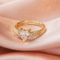 Macro shot of heart-shaped crystal ring with double row pave setting on gold band - Heart Gold/Halo Design