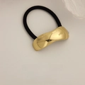 Elastic hair tie with a wavy gold metal accent and durable black rope cord - Glossy Irregular Curved Gold
