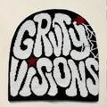 Detail of knitted jacquard GRIMY VISIONS lettering with red star on black beanie - Black with White Letters