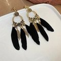 Detail of vintage gold hoop earrings with black feathers and metallic leaf charms - Clip-on Earrings / Black (Clip-on)