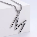 Detailed macro view of silver liquid metal texture on M letter pendant with box chain - Letter M (Pendant Only)