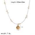 Detail of ocean-style necklace showing a gold scallop pendant with a white pearl inlay - Scallop Style (TN3554)