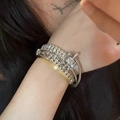 Close-up of punk style multi-layered silver metal bracelets on wrist with rivet accents - Cool Girl Shiny Diamond Bracelet