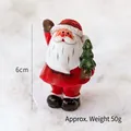 Miniature Santa Claus resin figurine holding a green Christmas tree for desktop decor - Standing Santa Holding Tree