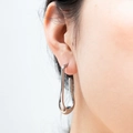Minimalist silver U-shaped stainless steel drop earrings with high-polish finish on a model - Cast U-shaped Earrings Steel Color