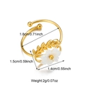 Detail shot of 18K gold stainless steel open ring with white flower and leaf accents - Gold