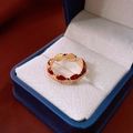 Detail of an adjustable gold ring featuring red enamel and micro-pave cubic zirconia - Heart Enamel Style / Gold