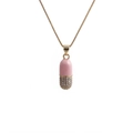 Macro view of a pink and gold pill pendant featuring micro-set zircon on a box chain - Box Chain / Pink