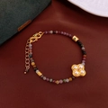 Detail of colorful tourmaline beaded bracelet with a gold clover pearl pendant on red fabric - 15# Bracelet-Gold Clover-Purple-Gold