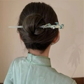 Detail of elegant Chinese style hair stick with green leaves and crystals on model's hair - Bamboo Joint Hair Stick