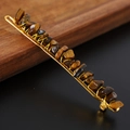 Macro detail of natural tiger eye crystal stones hand-wrapped with gold wire on a hair clip - Tiger Eye + Gold Clip