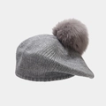 Detail of grey knitted beret featuring a fluffy fox fur pompom and ribbed texture - One Size / Gray