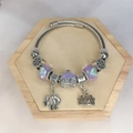 Silver beaded bracelet with pumpkin carriage and elephant pendants on wooden display tray - Purple