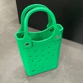 Detail view of green EVA hollow beach bag with dual handles and metal rivet fasteners - Green