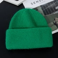Detail of bright green knit beanie with thick mohair texture and ribbed pattern on magazine - M (56-58cm) / Dark Green