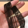 Close-up of black 2mm faceted crystal glass wheel beads held in hand for DIY jewelry - 1 Strand Approx. 200 Pieces/Pack (2mm) / Black