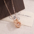 Rose gold antler necklace with a dancing cubic zirconia stone on a wooden display - XL494 Dancing Zircon Deer Horn Rose Gold