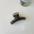 Detail of smoke grey translucent hair claw clip with golden spring on white surface - Medium-8cm / Transparent Black