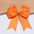 Detailed close-up of 6-inch orange ribbed ribbon fishtail bow hairclip for children - Orange