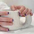 Short round French style press-on nails in blue and silver on a ceramic cup - HY307 Blue Silver French Short