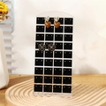 72 holes acrylic earring display stand on wavy wood base with floral decor - Transparent Black Grid
