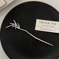Elegant silver bamboo shaped metal hair pin with detailed leaf textures on black tray - Bamboo Leaf Silver Small