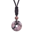 Macro detail of a round pink stone pendant with a hand-woven brown adjustable cord necklace - Rhodonite Necklace