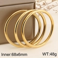 Three 18k gold-plated 6mm hollow stainless steel bangles leaning on a brown jewelry box - Gold (3 Circles)