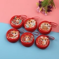 Detail of red round cartoon snake tinplate coin purse with zipper and lanyard - Round Year of the Snake