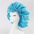 Detail view of smooth sky blue satin hair bonnet with a large decorative bow - Medium Single Layer Ribbon / Dark Blue