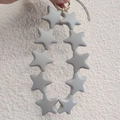 Hand holding a grey silicone star beaded keychain with gold clasp and cord - Bright Lime Gray (10 Stars)