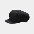 Detailed close-up of high-density cotton fabric texture on a black octagonal newsboy cap - Black