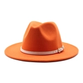 Detail of orange wool fedora hat featuring a white leather band and gold buckle - Orange