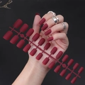 Close-up of matte dark red long square fake nails held by hand with silver rings - Frosted Dark Red