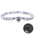 Macro detail of silver heart pendant with projection stone on zebra stone beads - Heart-White Turquoise