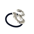 Detail view of a silver wave pattern metal buckle on a black elastic ponytail holder - Silver Figure-3