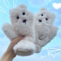 Cute white plush bear fleece gloves for winter warmth held against the blue sky - Crooked Face Bear / Off White