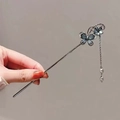 Silver metal hairpin with blue butterfly charms and elegant pearl tassels held in hand - Butterfly Flower