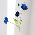 Faux blue poppy spray with three silk blooms and green leaves in a clear glass vase - Dark Blue