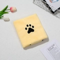 Close-up of yellow coral fleece pet towel featuring a black paw print embroidery detail - Yellow
