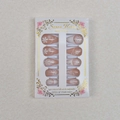 Detail of almond press-on nails with white snowflake prints and sparkling rhinestones - Nude Pink White Snowflake Style (WY-046) / 24Pcs Set